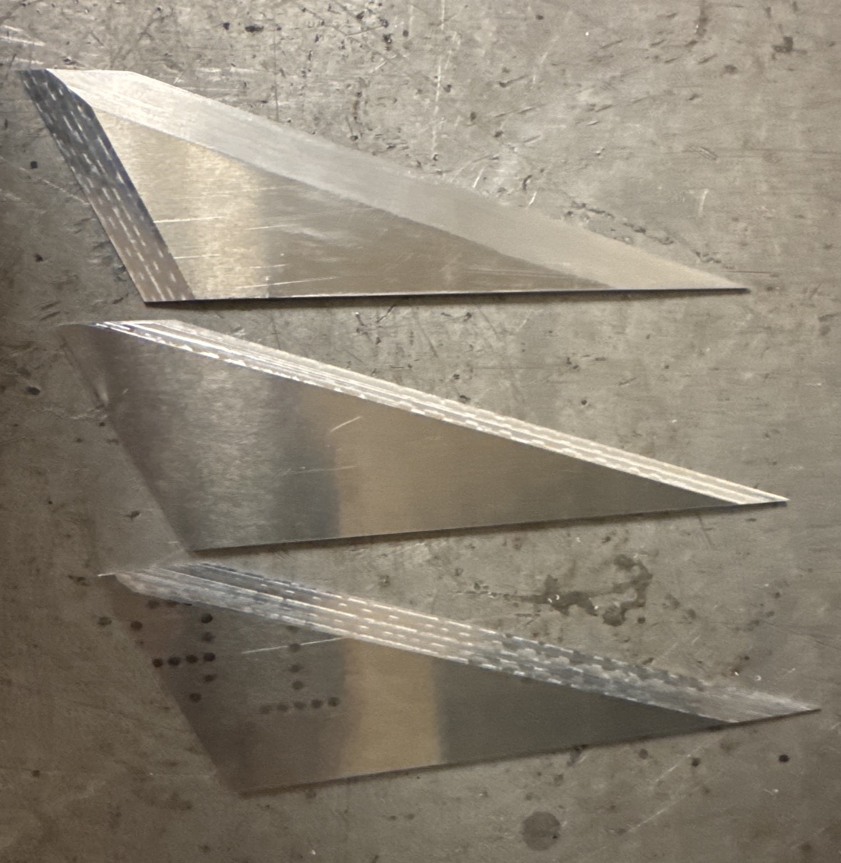 Three CNC-routed and beveled rocket fins.