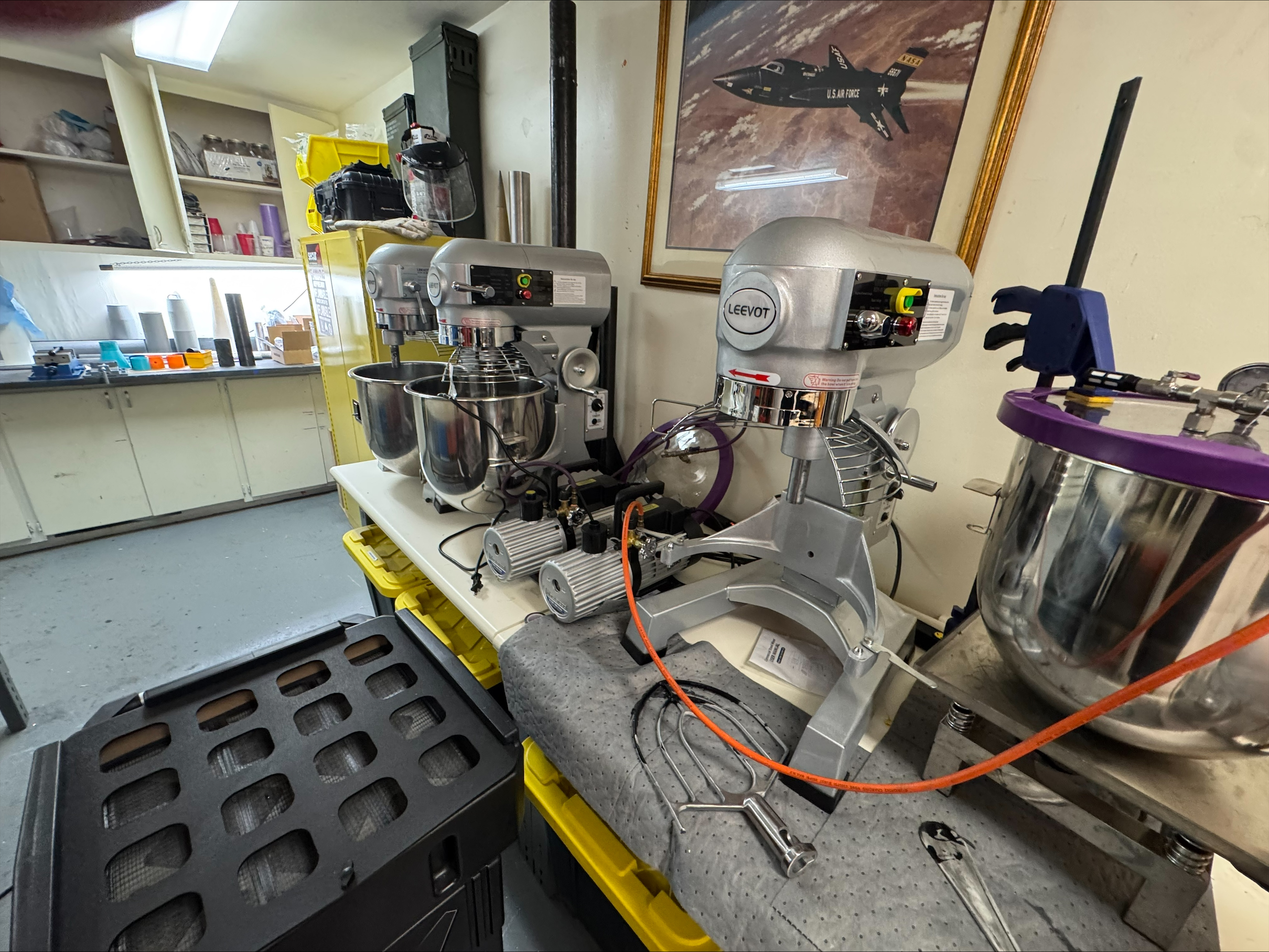 Laboratory workbench with mixers and processing equipment.
